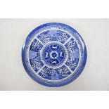 A Chinese blue and white plate with chrysanthemum decoration around a central roundel depicting four