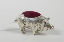 A sterling silver pincushion in the form of a pig, 1½" wide