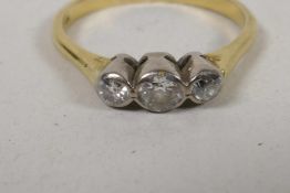 An 18ct gold three stone diamond ring, size R