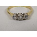 An 18ct gold three stone diamond ring, size R