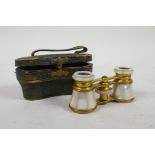 A cased pair of brass and mother of pearl opera glasses by Edward Messter of Berlin, 4" wide