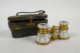 A cased pair of brass and mother of pearl opera glasses by Edward Messter of Berlin, 4" wide