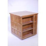 A 'Wrenman' Robert Hunter oak bookcase, with three open sides and cupboard, the fourth adzed top and