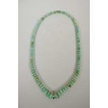 A graduated turquoise coloured hardstone bead necklace, 23" long