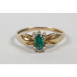 A yellow gold emerald set dress ring, approximate size 'N/O'