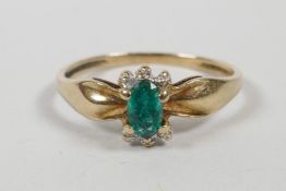 A yellow gold emerald set dress ring, approximate size 'N/O'