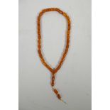 A string of faux amber prayer beads, 22" long