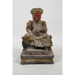 A Chinese carved and polychrome painted figure of an emperor seated on a throne, 8" high