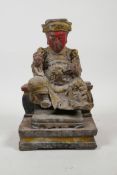A Chinese carved and polychrome painted figure of an emperor seated on a throne, 8" high