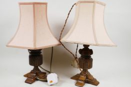 A pair of carved oak table lamps, 16" high including shades