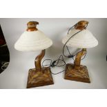 A pair of Art Deco style Crosa carved and moulded table lamps with frosted glass shades, 22" high