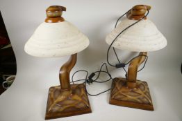 A pair of Art Deco style Crosa carved and moulded table lamps with frosted glass shades, 22" high