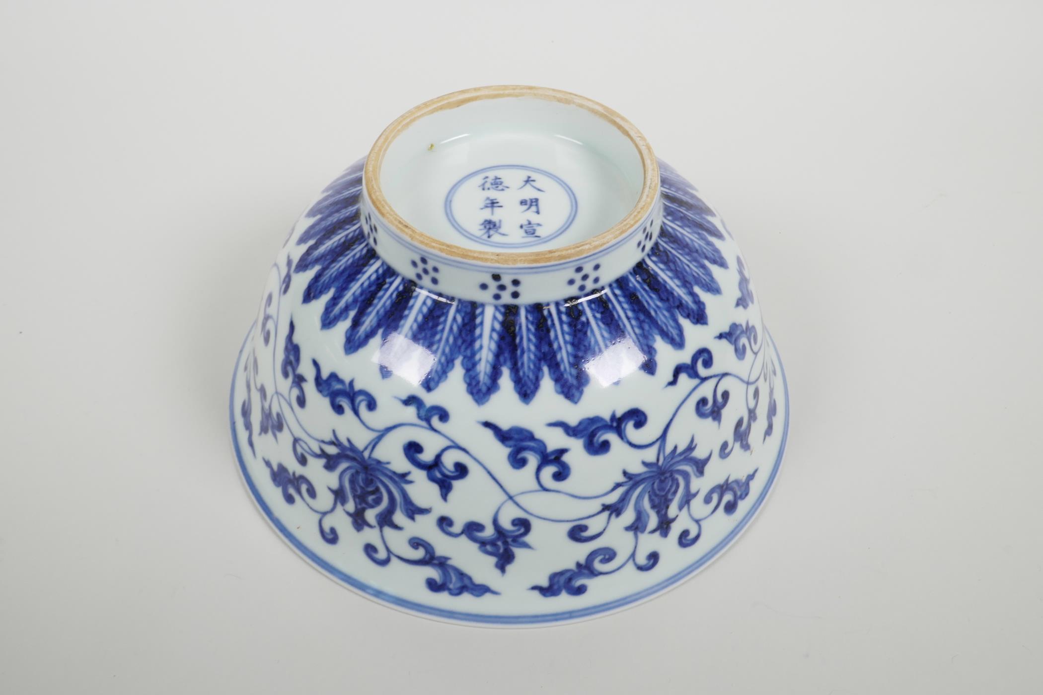 A Chinese blue and white porcelain bowl with scrolling lotus flower decoration, six character mark - Image 4 of 4