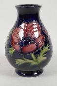 A late C20th Moorcroft pottery vase of bulbous form with floral decoration, 5½? high