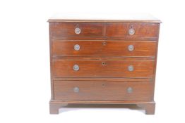 A Georgian mahogany chest of two over three drawers, with oak lining and scratched moulded fronts,