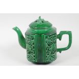 A Chinese green glazed porcelain teapot, the body decorated with pierced reticulated panels of