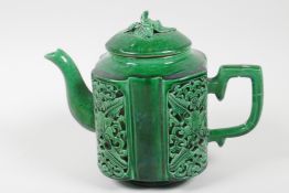 A Chinese green glazed porcelain teapot, the body decorated with pierced reticulated panels of