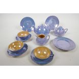 A mid C20th Staffordshire lustreware child's miniature tea service, comprising a teapot, sugar bowl,