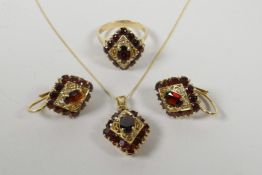 A suite of 14ct yellow gold and garnet set jewellery including a ring, pendant necklace and pair