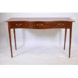 A C19th mahogany serpentine front three drawer serving table, with original brass swan neck handles,