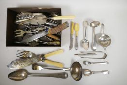 A collection of hallmarked silver and silver plated flatware, including strainers, fish servers,