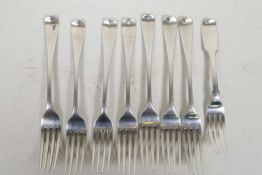 Eight large Georgian/Regency sterling silver forks, seven by William Eaton and one by another maker,