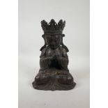 A Chinese bronzed metal figure of Buddha, with distressed gilt patina, impressed six character