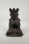 A Chinese bronzed metal figure of Buddha, with distressed gilt patina, impressed six character