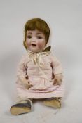 A Simon & Halbig doll No 126, with bisque head, sleeping eyes and two teeth, composition body and