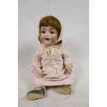 A Simon & Halbig doll No 126, with bisque head, sleeping eyes and two teeth, composition body and