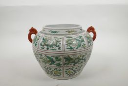 A Chinese Ming style two handled porcelain jar with green and yellow enamel panels depicting