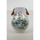 A Chinese famille verte pottery vase with two deer mask handles, and decorated with immortals and