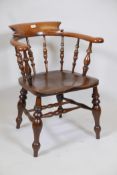 A C19th beech smoker's bow chair, with saddle shaped elm seat