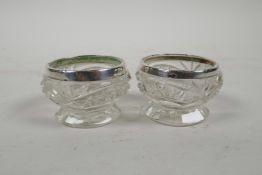 A pair of cut glass and hallmarked silver salts, marked Birmingham 1943