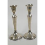 A pair of hallmarked silver candlesticks, 7" high (weighted)