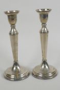 A pair of hallmarked silver candlesticks, 7" high (weighted)