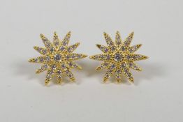 A pair of silver gilt car studs in the form of stars set with cubic zirconium