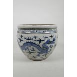 A Chinese blue and white pottery jardiniere decorated with two dragons chasing the flaming pearl,