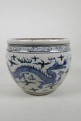 A Chinese blue and white pottery jardiniere decorated with two dragons chasing the flaming pearl,