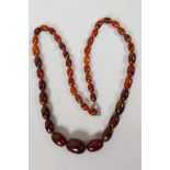 A string of graduated faux amber beads, 28" long