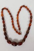 A string of graduated faux amber beads, 28" long