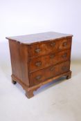 A late C18th/early C19th walnut veneered three drawer chest with a shaped top and bracket feet,