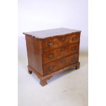 A late C18th/early C19th walnut veneered three drawer chest with a shaped top and bracket feet,