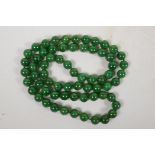 A string of green jade beads, 32" long