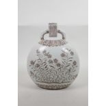 A Chinese blue and white porcelain two handled moon flask with floral decoration, 10" high