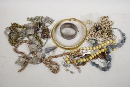 A quantity of costume jewellery including millefiori enamel beads and a Chinese bangle decorated