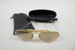 A pair of vintage Ray-Ban USA aviator sunglasses marked 58-14 on the frame, in hard ultralight case