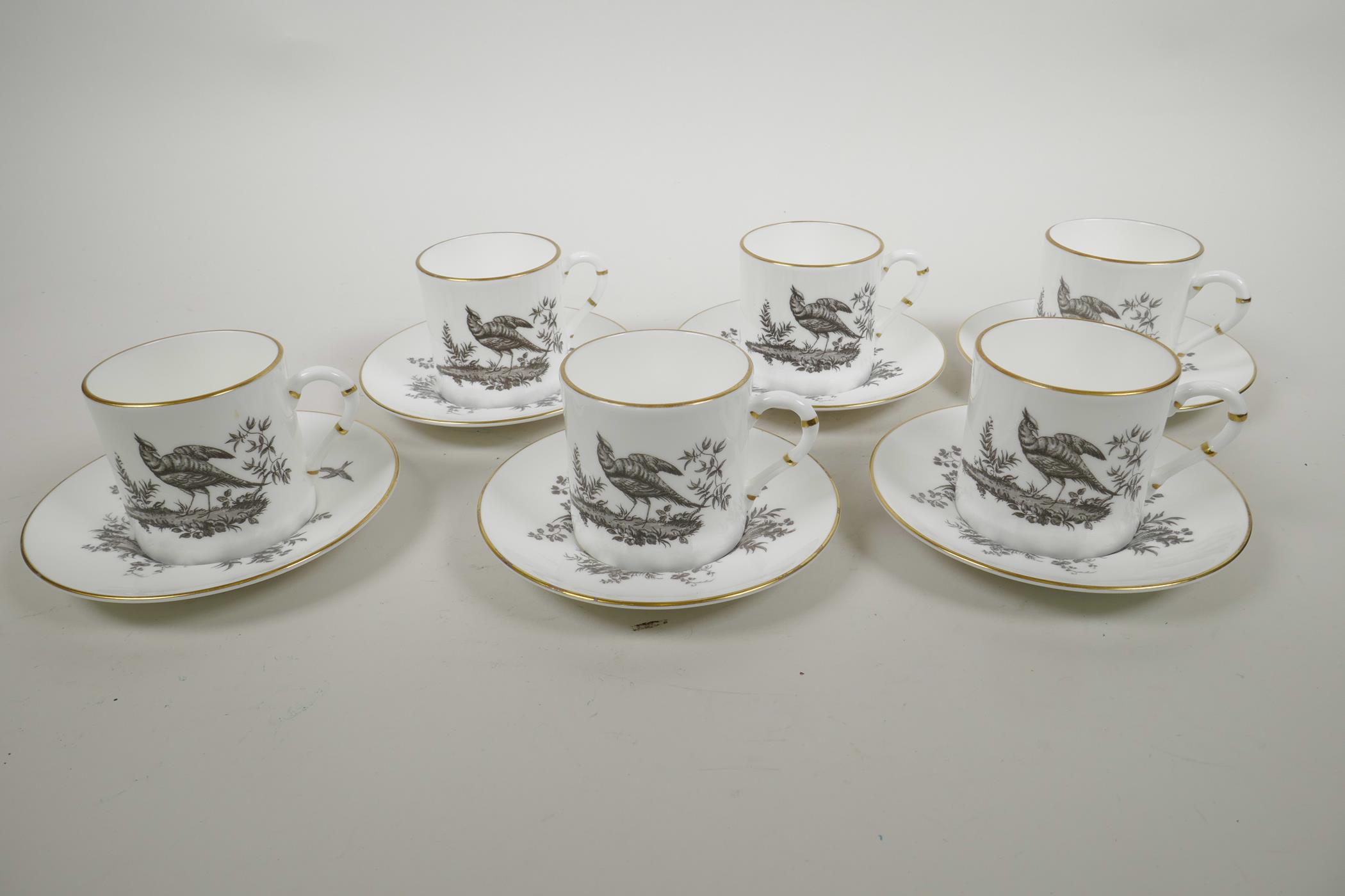 A Royal Worcester porcelain coffee service comprising six cups and saucers with monochrome