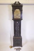 An C18th eight day long case clock with carved decoration, the brass dial with gilt spandrels, the