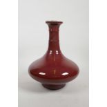 A Chinese sang de boeuf glazed vase with ribbed neck, four character mark to base, 11½" high